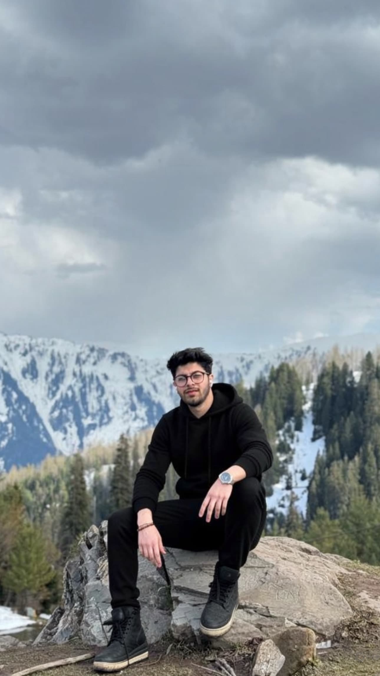 Mustafa Madraswala sitting in the mountains